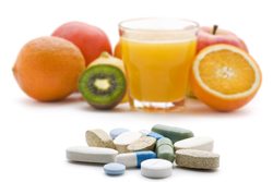 Pills with fresh fruit in background isolated